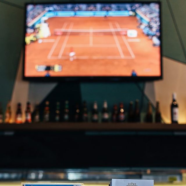 A match on the TV above a bar